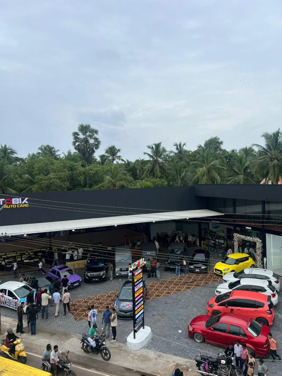 The AUTOBIX AUTO CARE centre in Theyyala on opening day, bays full and the forecourt packed