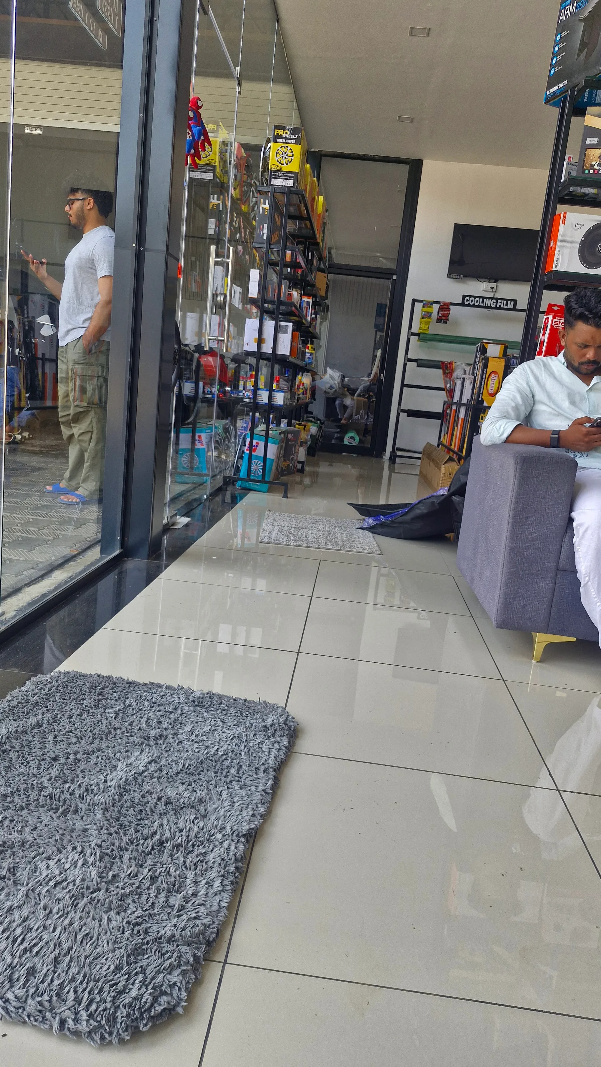 The air-conditioned customer lounge at AUTOBIX AUTO CARE, with sofas facing the bays