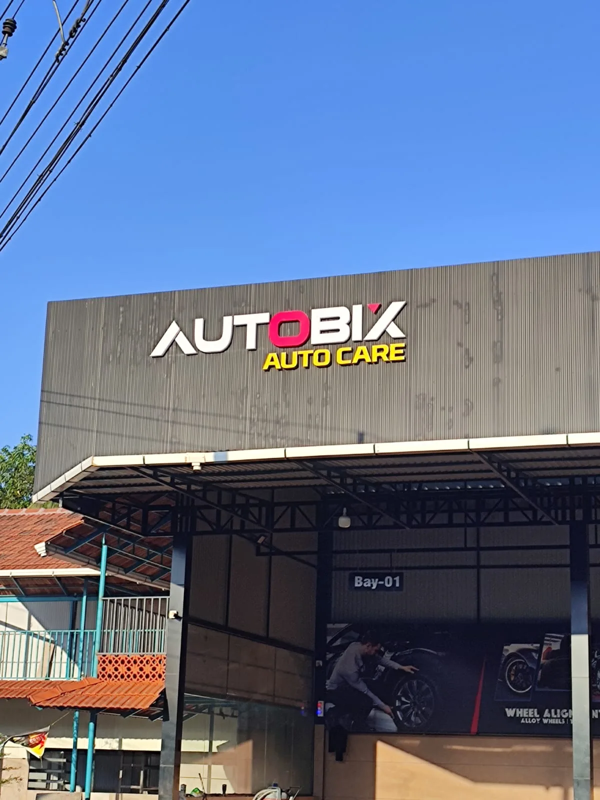 Bay 01 at AUTOBIX with a car being detailed under the canopy