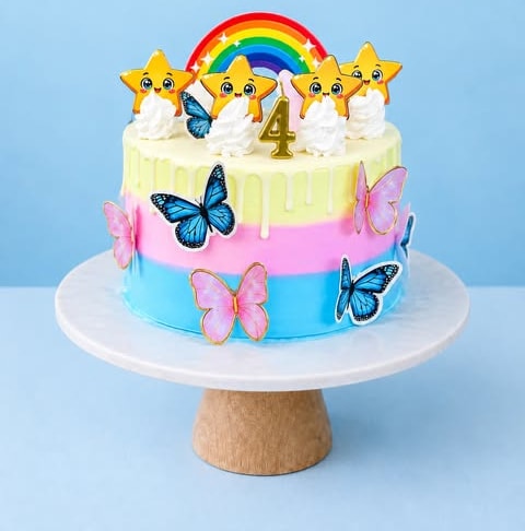 A colourful celebration cake with butterflies and stars