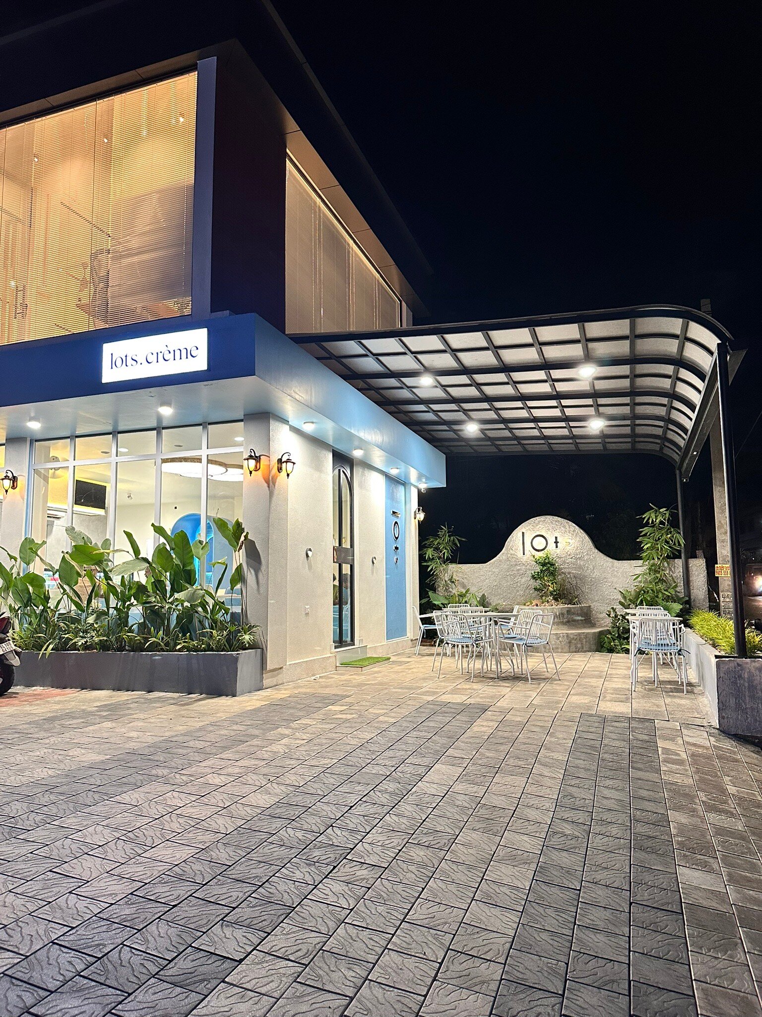 Covered terrace and outdoor seating at Lots. Crème