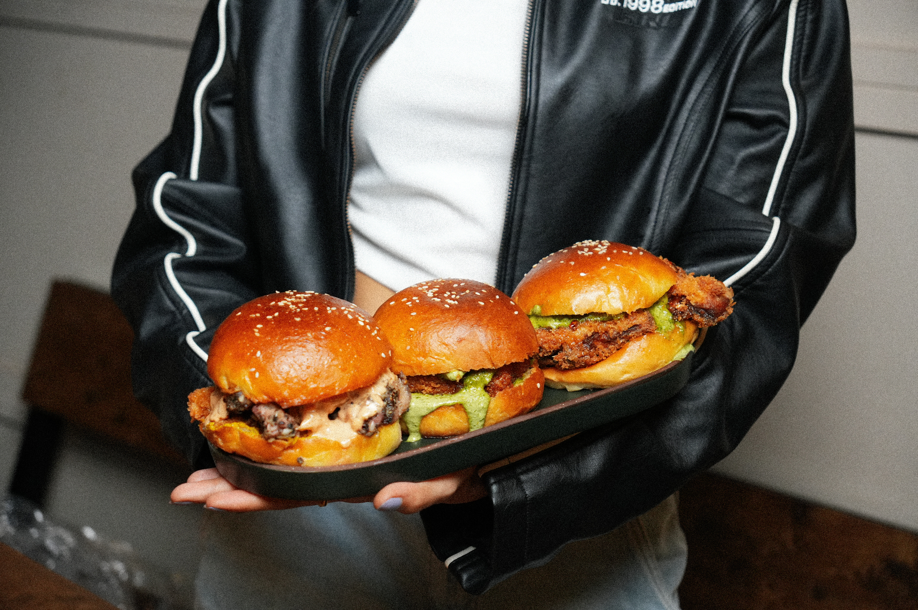 Three PuKa sliders held on a dark platter
