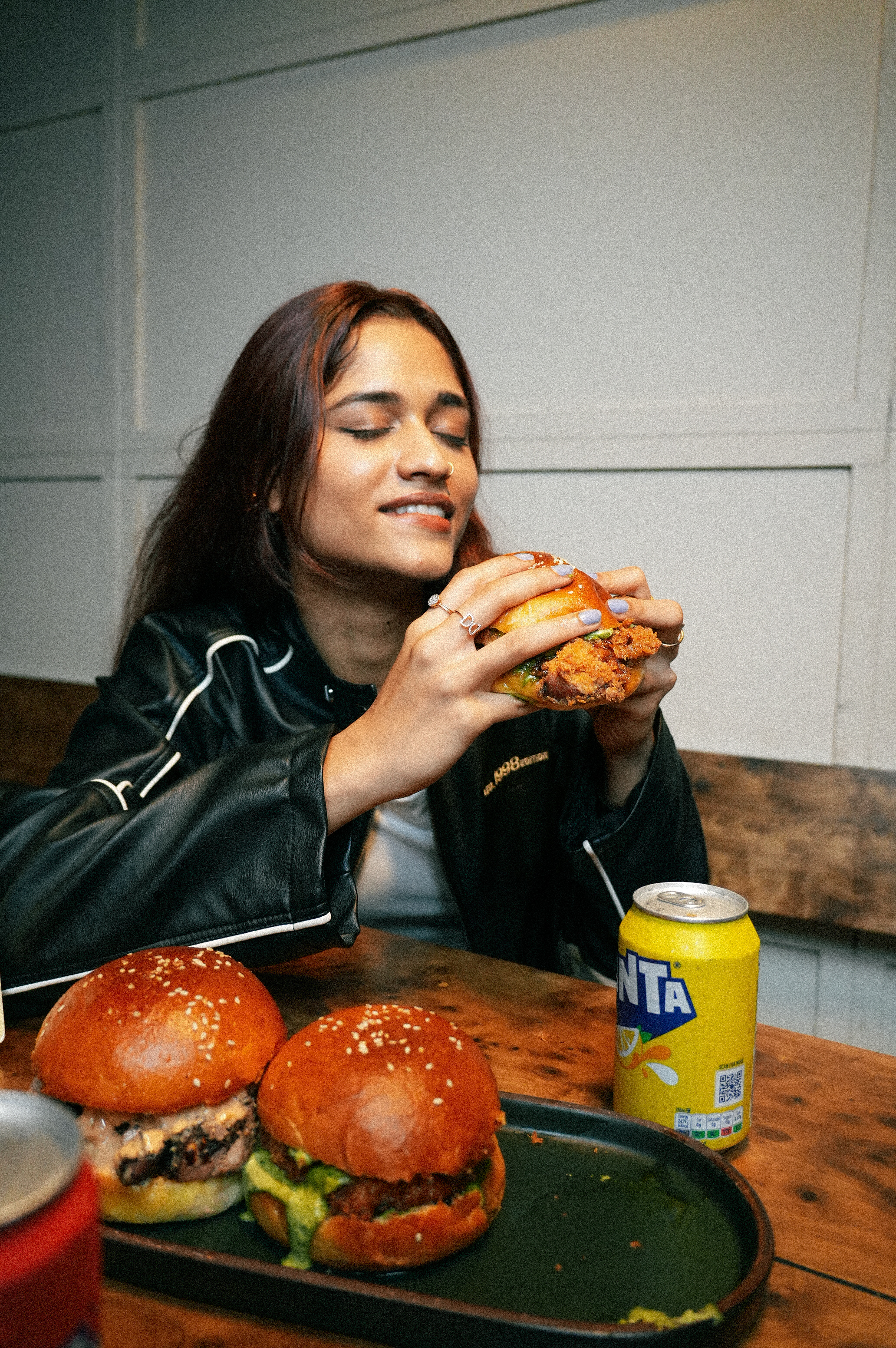 Guest biting into a PuKa smoked burger
