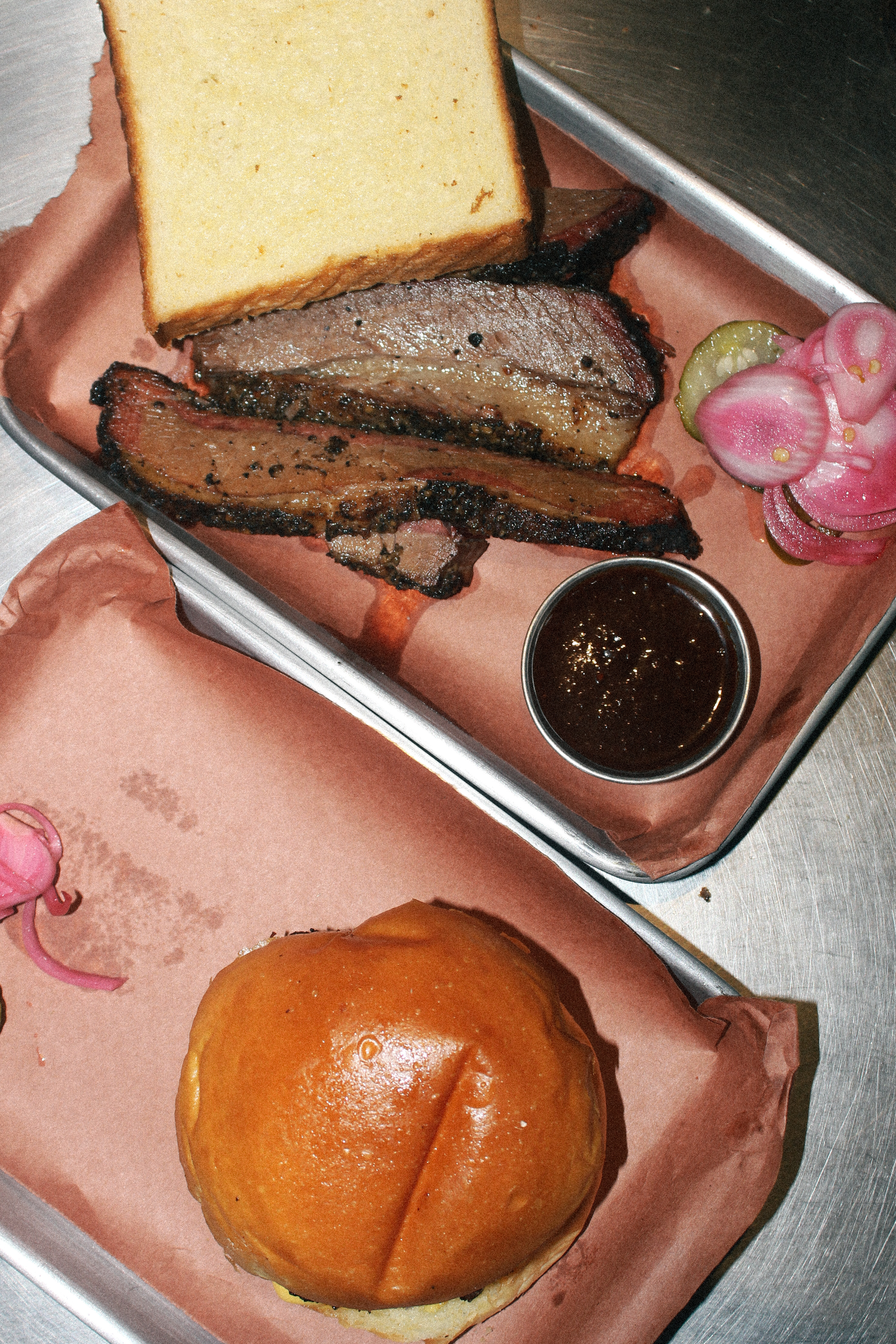 Brisket platter and burger trays from the pit