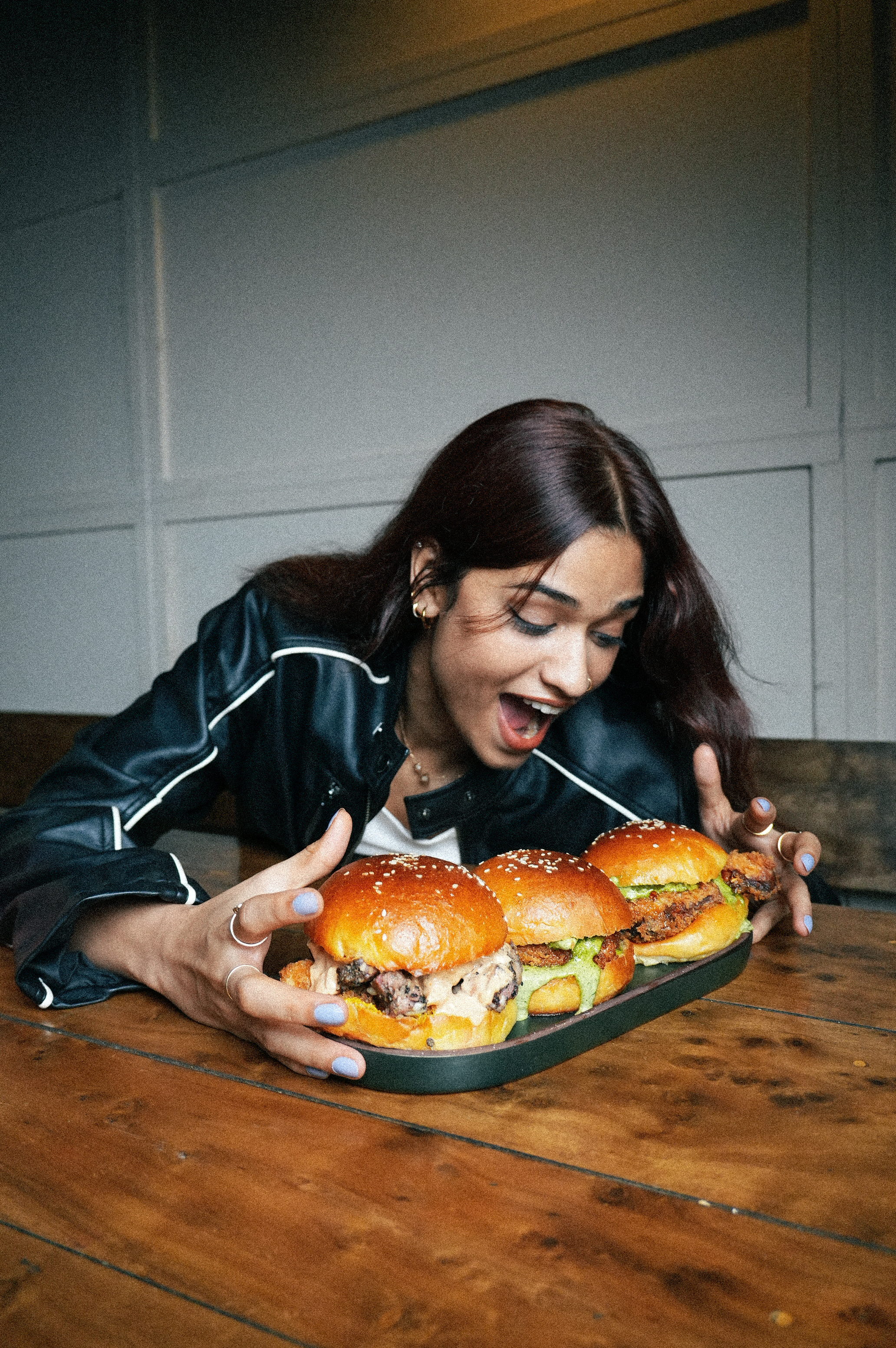 Guest reacting to a platter of smoked sliders