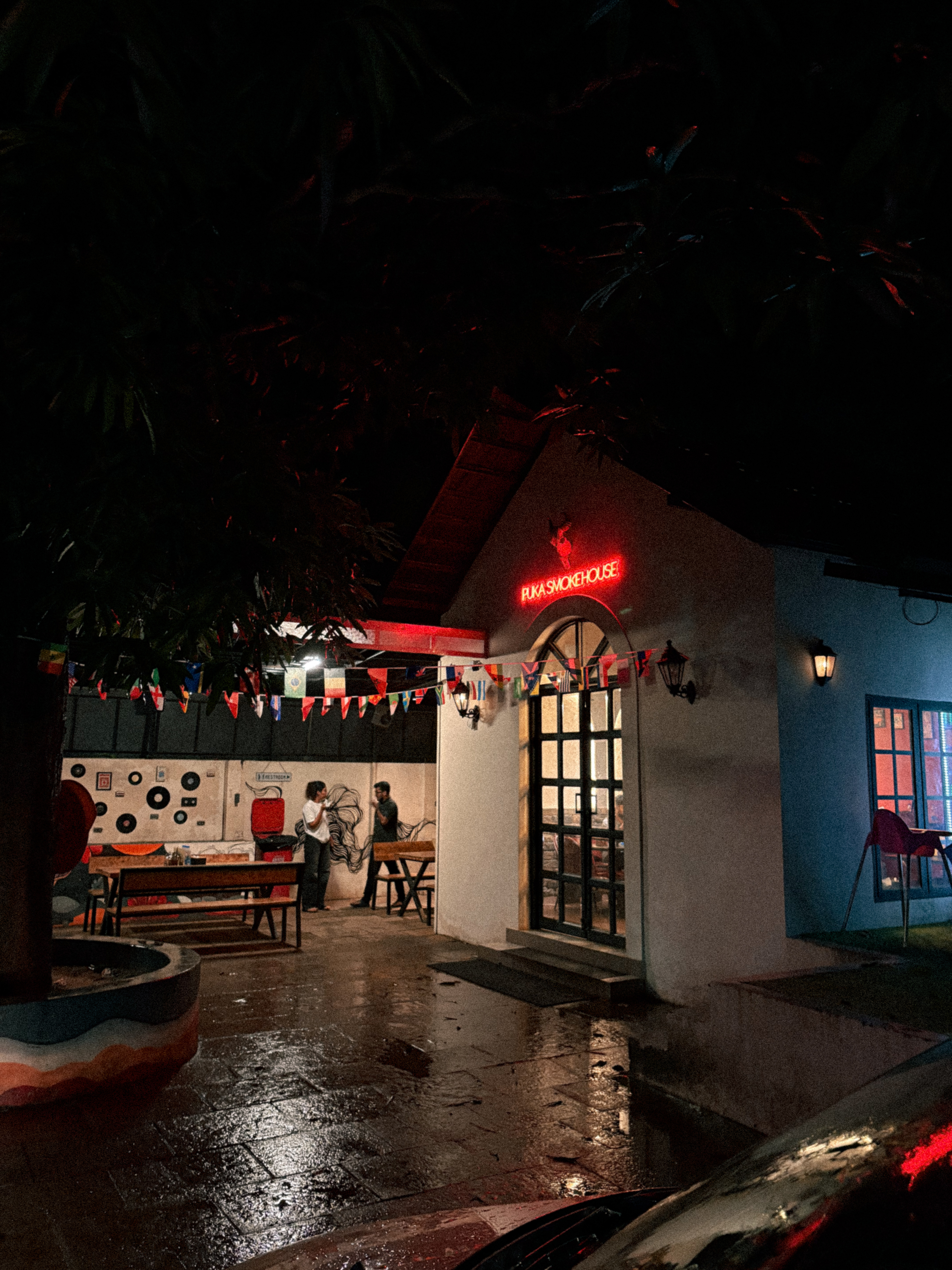 PuKa Smokehouse entrance glowing red at night